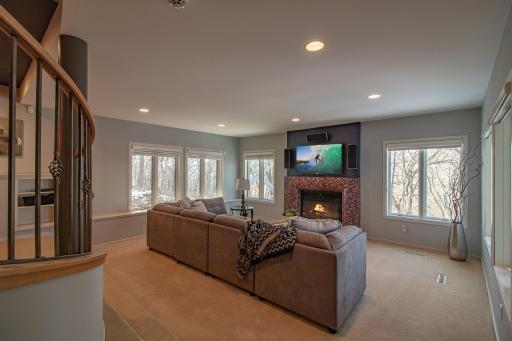 Lower level family room with wood fireplace with Mosaico Tile