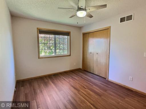 One of the 2 upper level bedrooms with newer flooring.