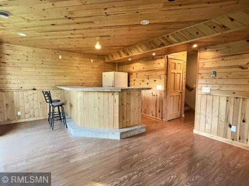 The lower level of the home is lined with knotty pine giving you the up north cabin feel. The lower level great room offers a built in bar ideal for entertaining friends and family