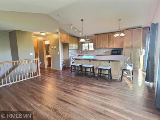 The remodeled kitchen and vaulted ceilings brings the openness of this area of the home to life. The upgraded kitchen now showcases a large center island along with a ton of new cabinets.