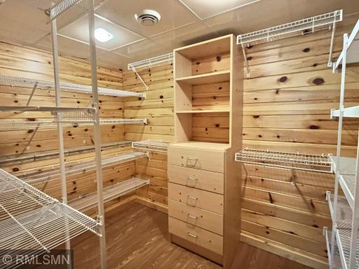 The walk in closet has ample shelving and a built in dresser ready for you to fill up.