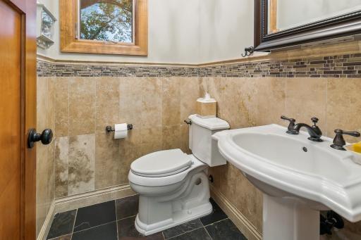 Main floor tile guest bath in the back hall