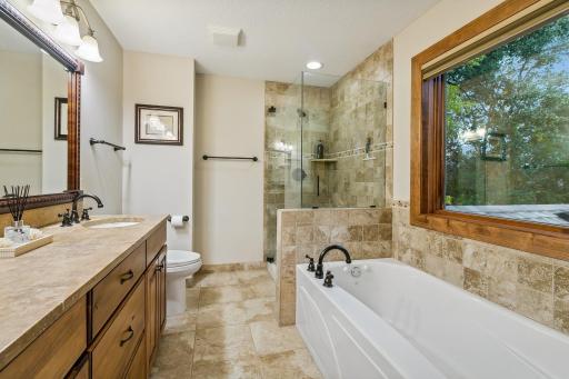 Primary Ensuite with separate tub and shower, tile floors and backsplash....