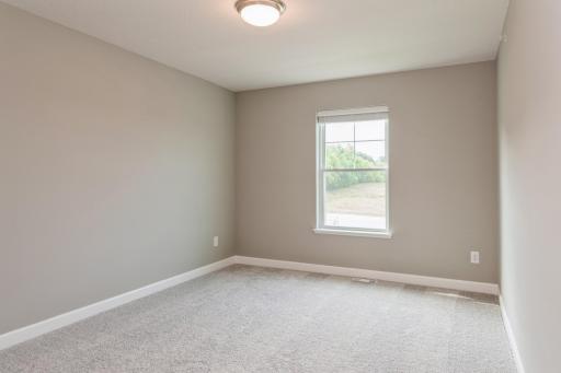 Each of the home's secondary bedrooms on the upper level come perfectly sized and all feature a spacious closet. *Photos are of another home, colors and finishes may vary.