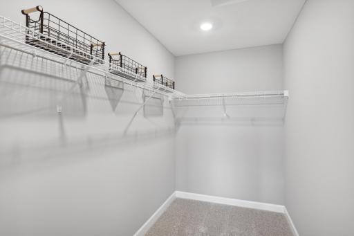 The owner's suite features an incredible walk-in closet. *Photos are of another home, some features and colors may vary.