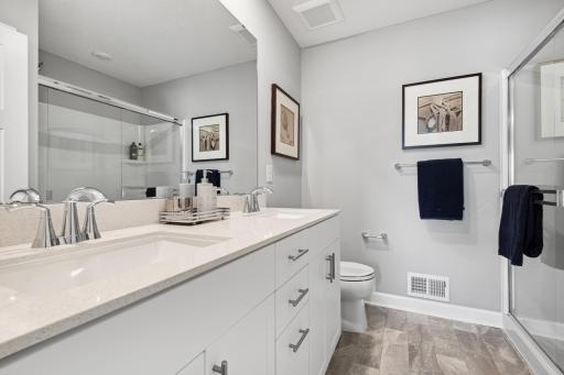 Private owner's suite bathroom with double sink vanity and walk-in shower! *Photos are of another home, some features and colors may vary.