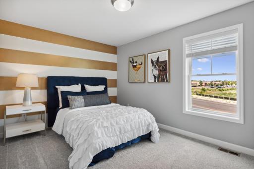 Another one of the spacious secondary bedrooms. *Photos are of another home, some features and colors may vary.