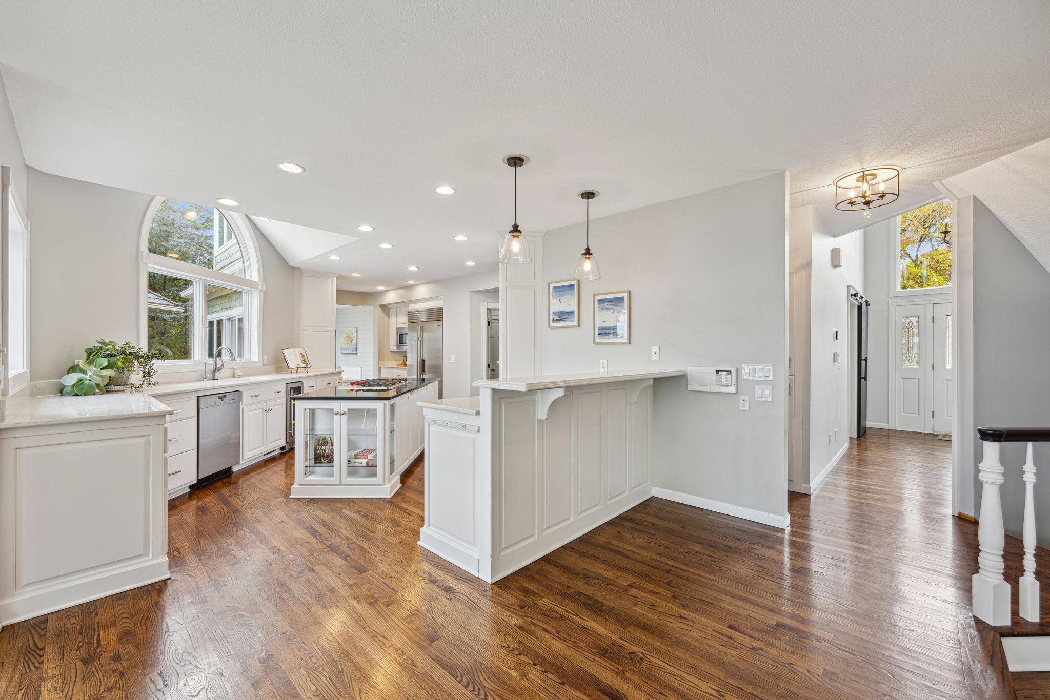 Kitchen has recessed lighting and quartz countertops.