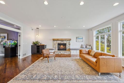 Family room is open to piano/living room with transom window and french doors.