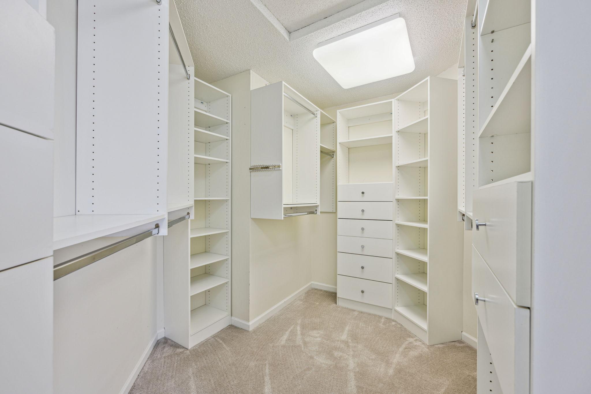 Primary closet has built in shelving.