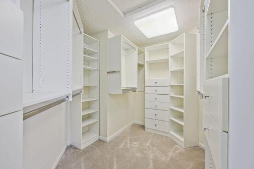 Primary closet has built in shelving.