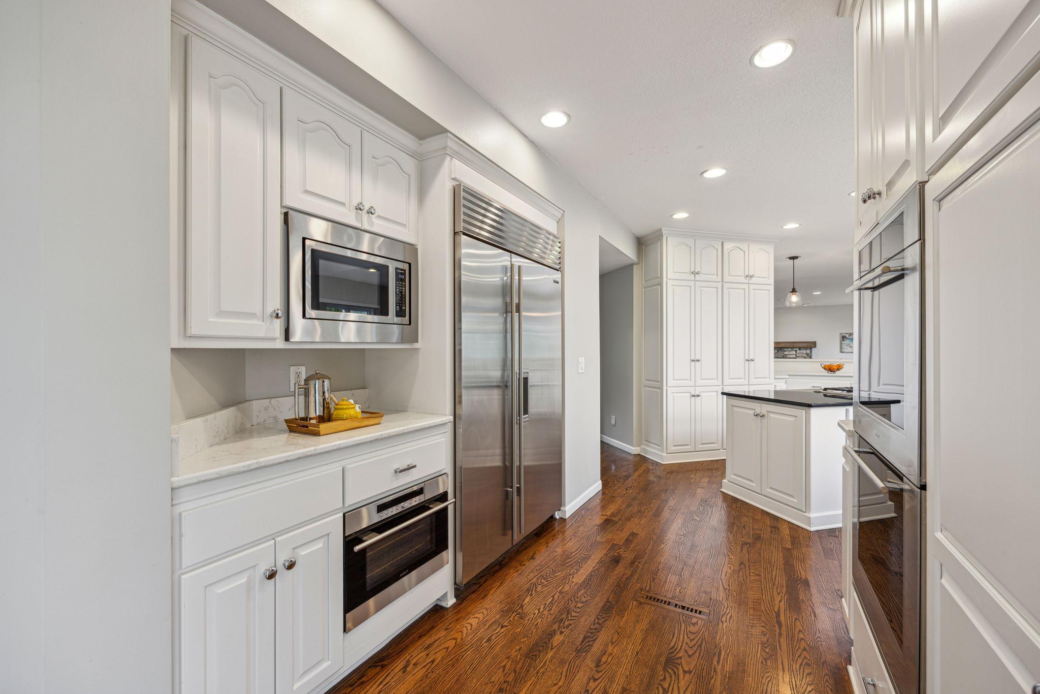 Double ovens, Microwave, and Subzero fridge.