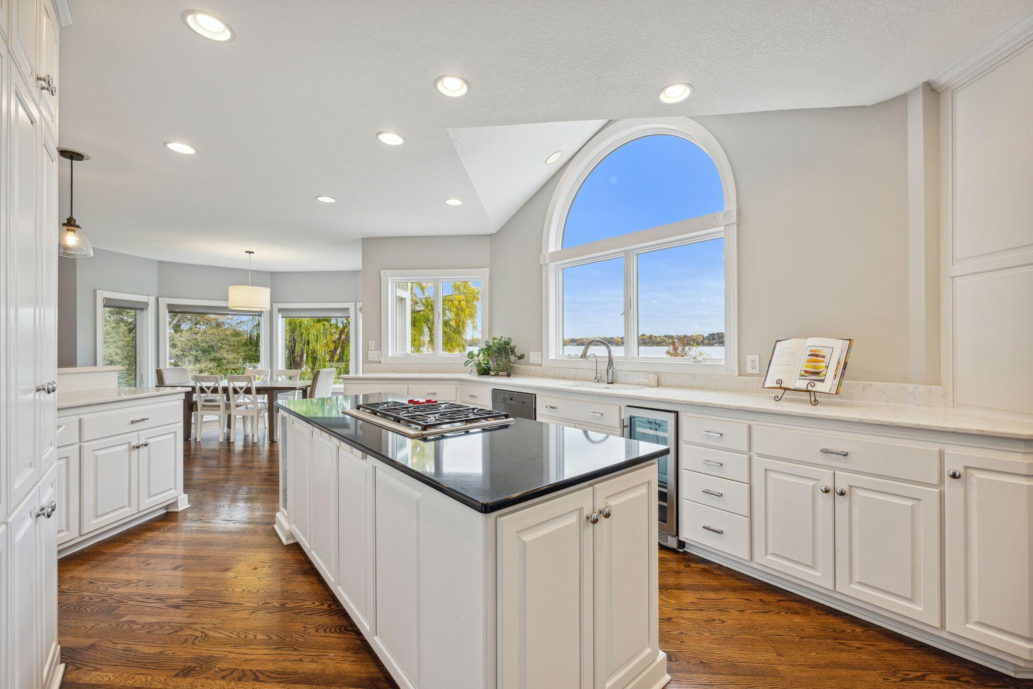 Wolf cooktop, Miele Dishwasher and wine fridge, kidney shaped fridge and beautiful window above the sink to enjoy the everchanging views of the lake from dawn to dusk.