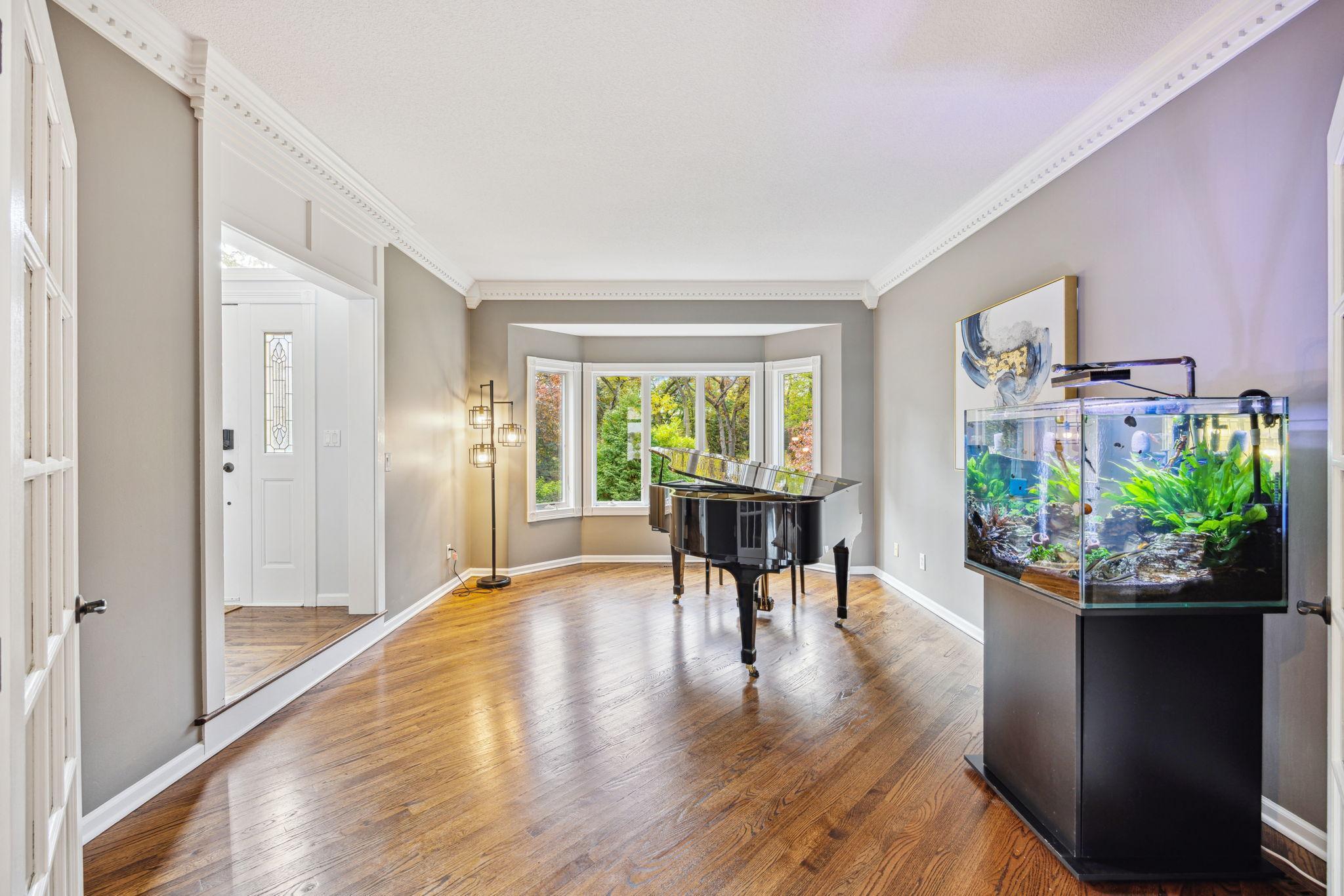 Piano room/Living room has bay window and is just off the entry.