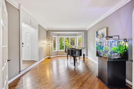 Piano room/Living room has bay window and is just off the entry.