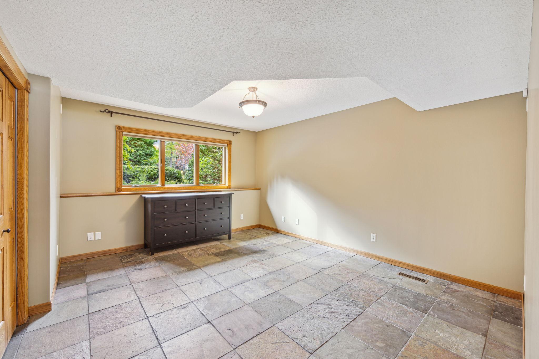 5th bedroom in lower level with daylight windows.