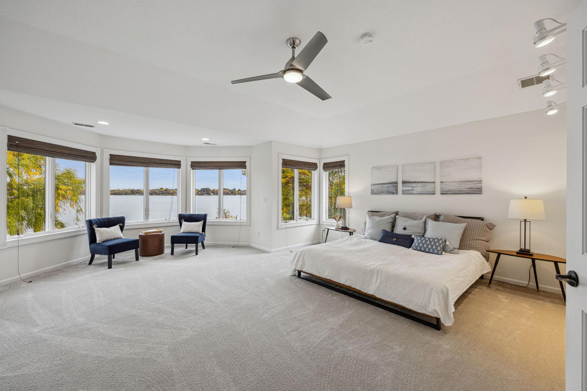 What a view to wake up to. You walk in the Primary bedroom and it feels like you could jump right into the lake from the large bay window.