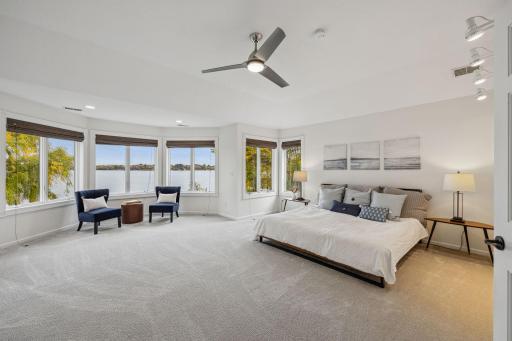 What a view to wake up to. You walk in the Primary bedroom and it feels like you could jump right into the lake from the large bay window.