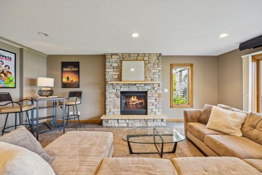 Gas fireplace with stone surround.