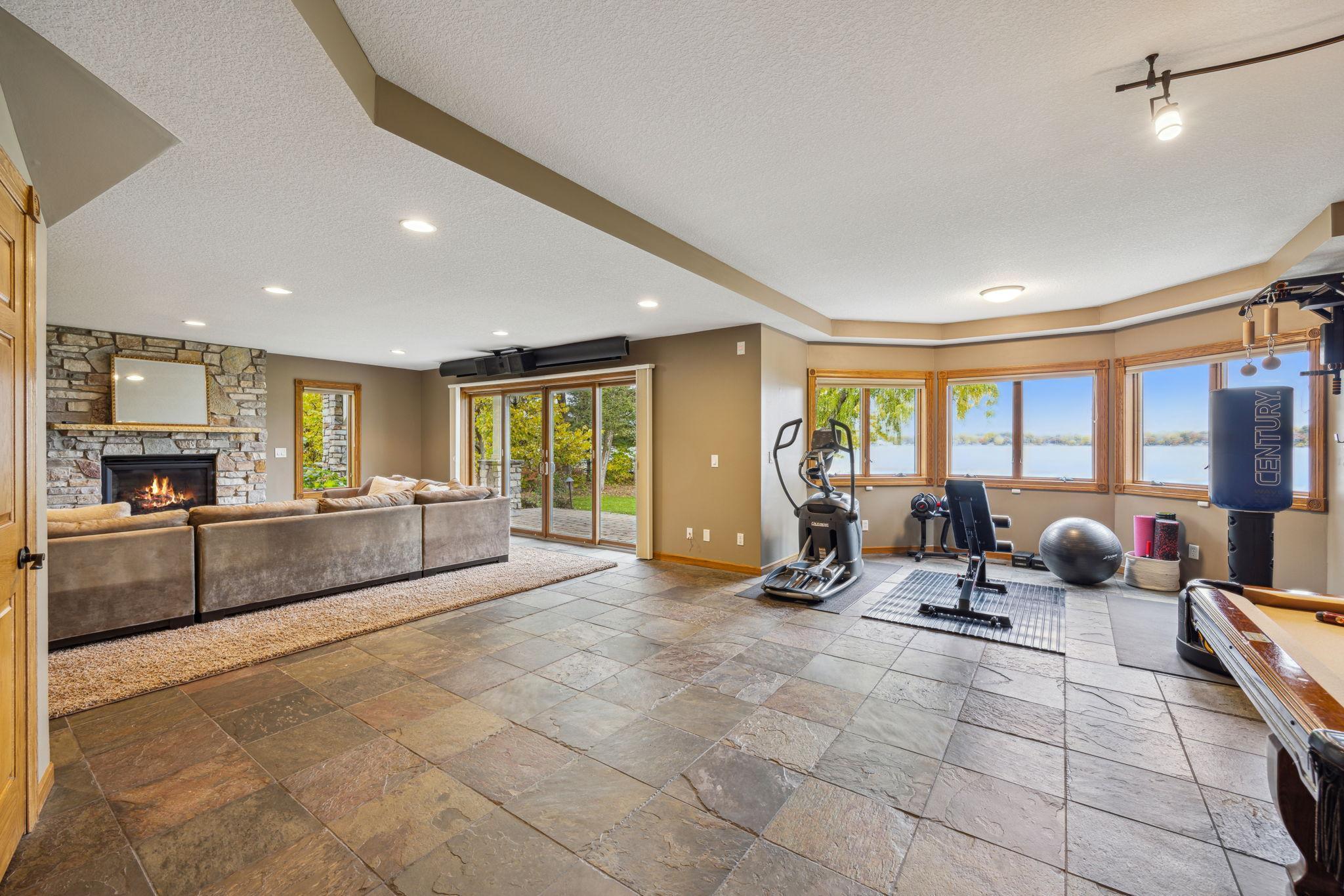 Slate floors and workout area, or game table area could be in the bay with lake views.