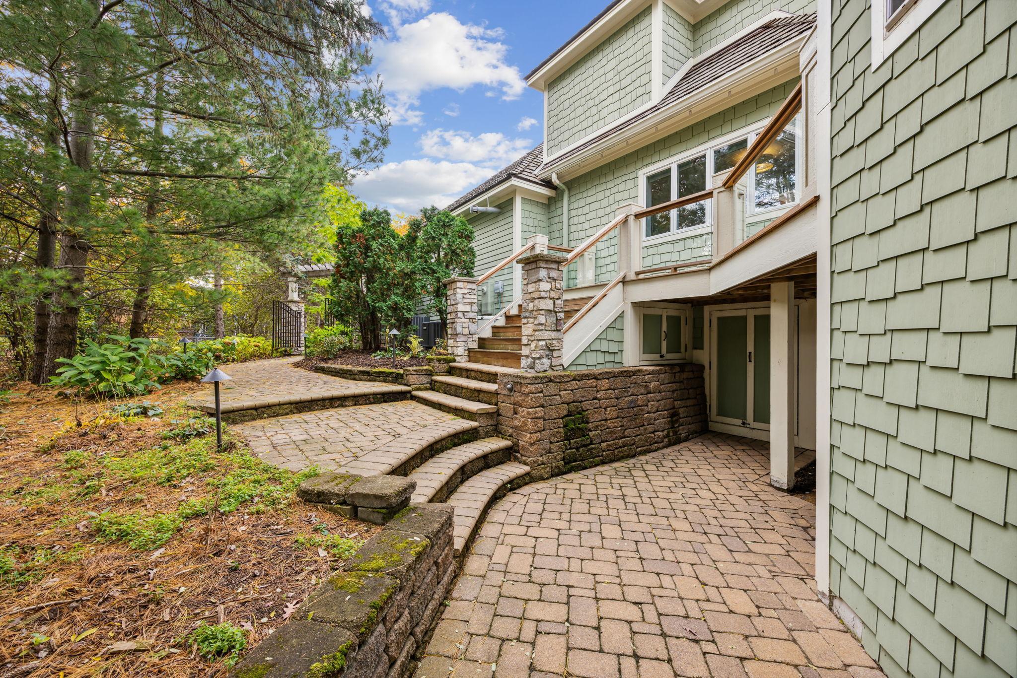 Lower level pavers lead to storage under the house for garden supplies.