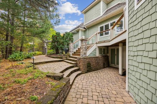 Lower level pavers lead to storage under the house for garden supplies.