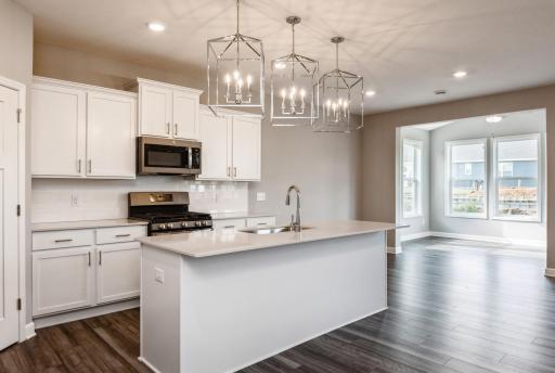 Enjoy plenty of seating at the kitchen island and dining area adjacent to the kitchen. Perfect for entertaining or having a family meal together.
