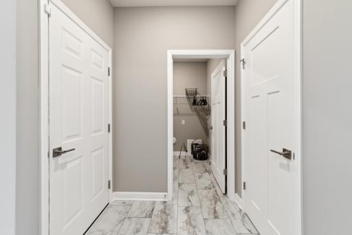 A warm welcome to the home, this mudroom is located near an entry closet and the laundry room. This entry provides enough space for a bench, cubbies and coat hooks. (Photo of decorated model, actual home's finishes may vary slightly)