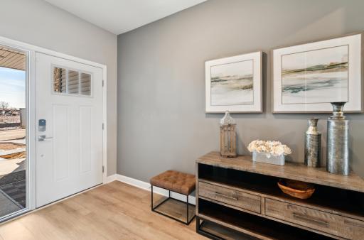 Make the best first impression with this bright and open foyer. Thoughtfully-designed to leave plenty of room for your guests to arrive and feel comfortable. (Photo of decorated model, actual home's finishes may vary slightly)