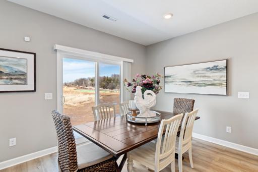 Soaked in natural sunlight, the homes eat-in dining room has ample space for a dining table located in the heart of the home. (Photo of decorated model, actual home's finishes may vary slightly)