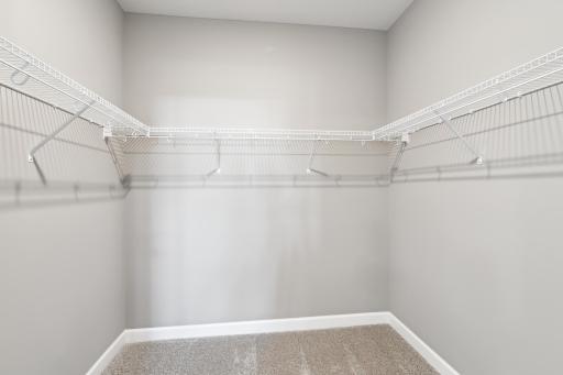 The owner's suite features an incredible walk-in closet. (Photo of decorated model, actual home's finishes may vary slightly)