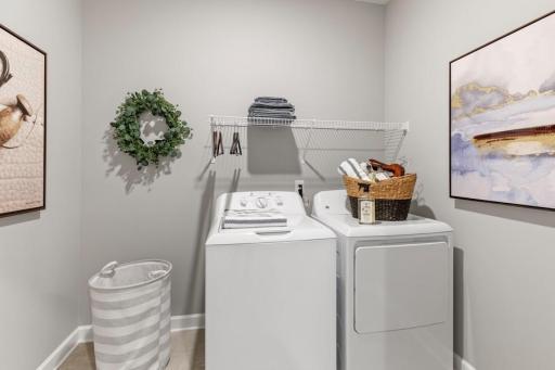 Conveniently located on the main level, the laundry room is next to the mudroom. (Photo of decorated model, actual home's finishes may vary slightly)