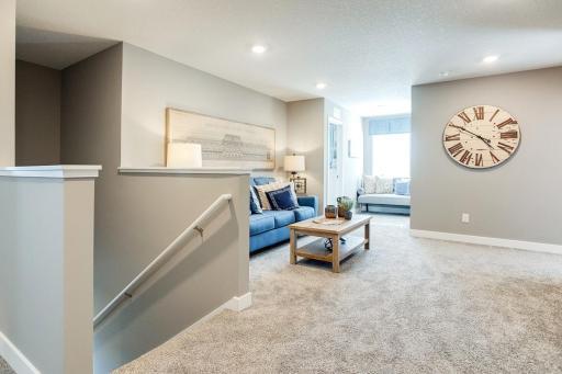 Atop the staircase resides this game room (or loft), which can serve as that perfect place for a second family space and is just steps from each of the home's four second story bedrooms