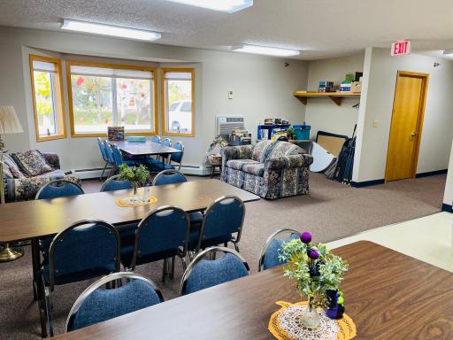 Community room complete with couches, tables and kitchen