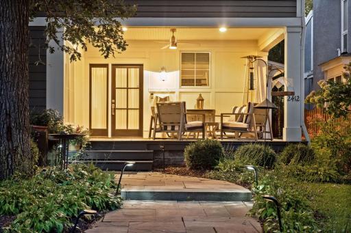 A large covered front porch provides an outdoor living area and an inviting welcome to the home.