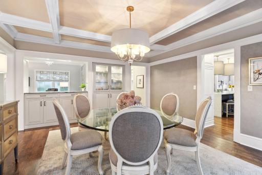 An open counter looks into the main level den and provides a wonderful bar or service area for entertaining. This spacious dining room can accommodate large groups.