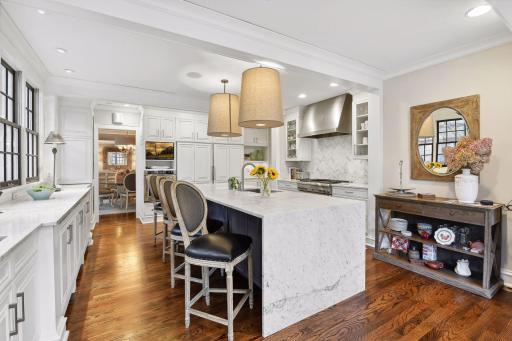 The large center island kitchen is a dream with marble countertops, luxury appliances, abundant counter space and storage, comfortable seating at the island or informal dining area.