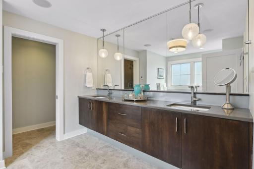 Spacious primary en suite bath with double vanity, water closet, walk-in shower, and soaking tub.