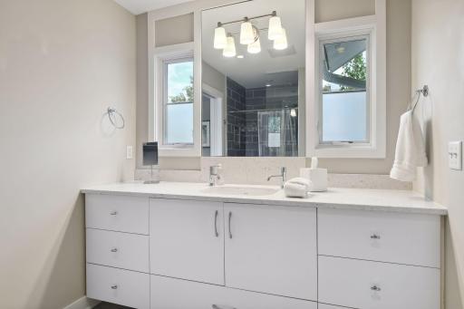 This 3/4 Jack and Jill bath serves the second and third bedrooms. Casement windows provide lovely eastern morning light and fresh air, as desired.