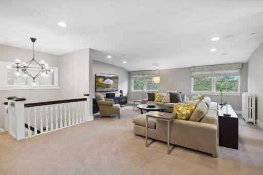 The third floor family room features a spacious living area, bar area, and full bath.
