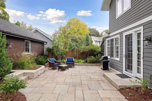 Stone paver patio and professionally landscaped garden beds. A lovely private space for grilling and outdoor living.