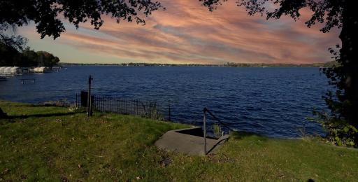 far-reaching westerly views of Lower Lake Minnetonka. Walkable to Excelsior via the trail. Level lot 8-10 ft. elevation to the sand packed lake shore