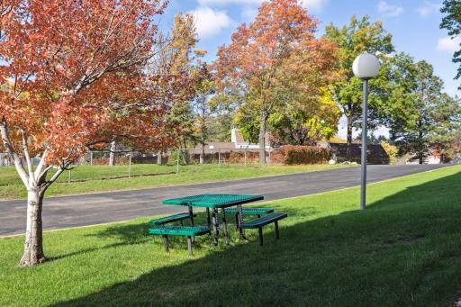 Picnic table overlooking the pickleball courts behind the building