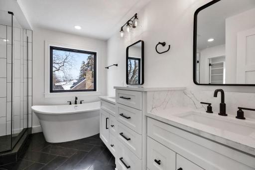 Relax in this amazing spa-like bath featuring custom walk-in shower, freestanding tub, heated tiled floors. Pictures of previously built house.