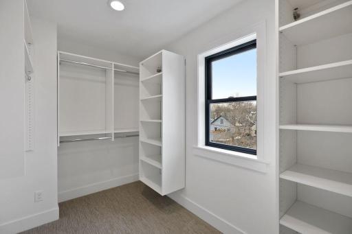 Walk-in closet with custom shelving. Pictures of previously built house.