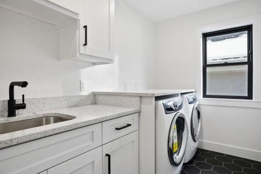 Convenient upstairs laundry with plenty of cabinets and counter space. Pictures of previously built house.