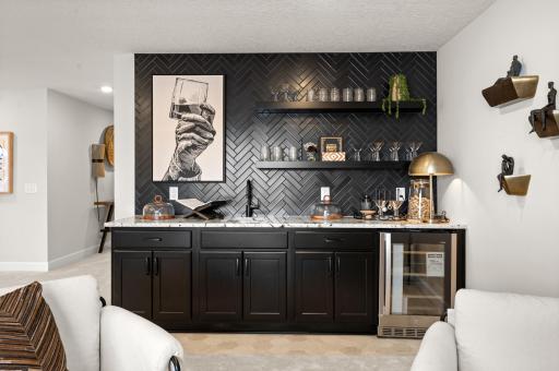 A black herringbone tiled wall with floating shelves is an exceptional backdrop to the wet bar.