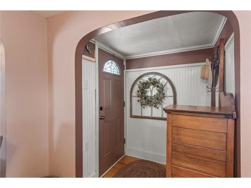 This cozy home boasts charm throughout with gleaming hardwood floors and stunning archways which elevate the space.