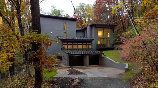 It is nestled in the woods of North Oaks with gorgeous and intentional natural surroundings.