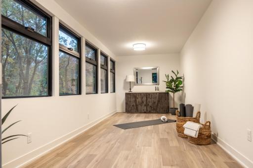 This flex space has a private entrance! It is perfect for a yoga/meditation/exercise space/office, etc. With the abundant windows you will feel like you are up in a tree house!